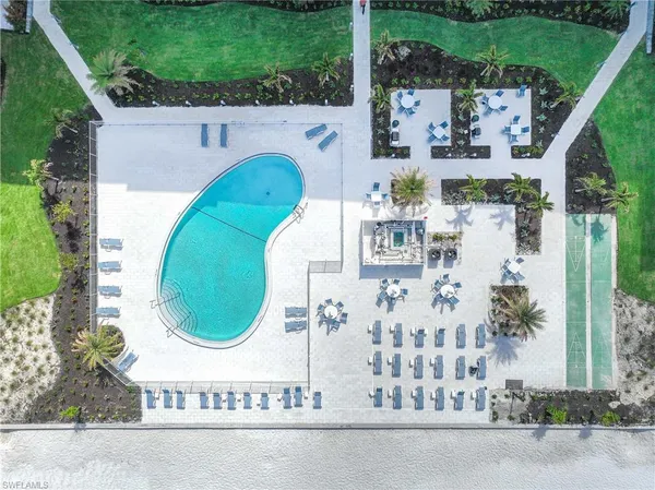 an aerial view of a house with swimming pool and outdoor seating