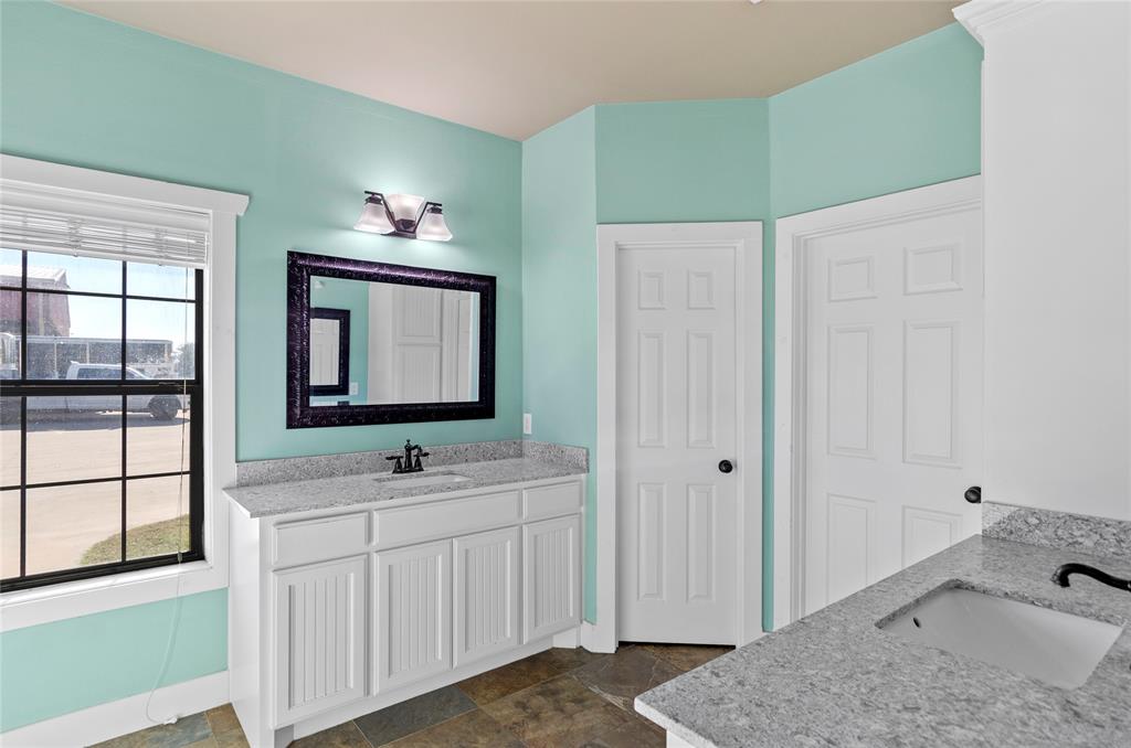 395 Yacht Club Road Oak Point, TX 75068 - Photo 19 of 23 Bathroom featuring two vanities and stone finish floors