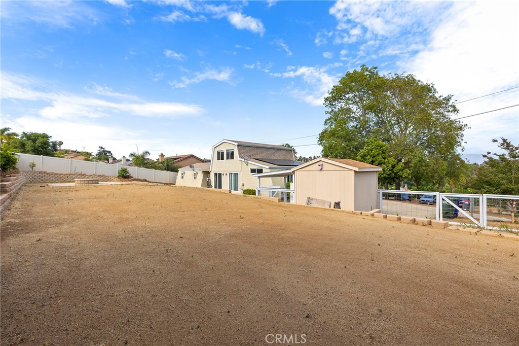 410 Palomino Road Fallbrook, CA 92028 - Photo 17 of 25 a view of a house with a yard and large trees