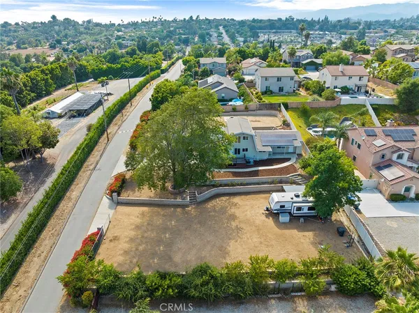 an aerial view of residential houses with outdoor space and river