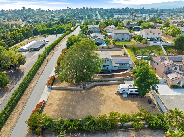 an aerial view of residential houses with outdoor space and river