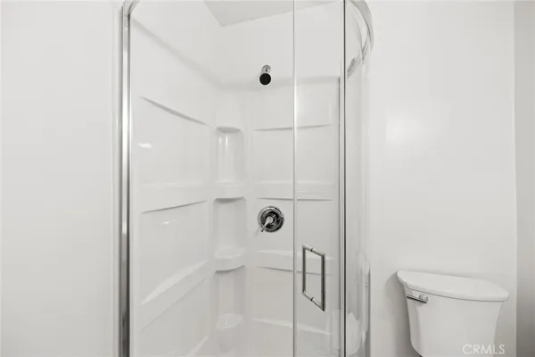 a bathroom with a shower and toilet