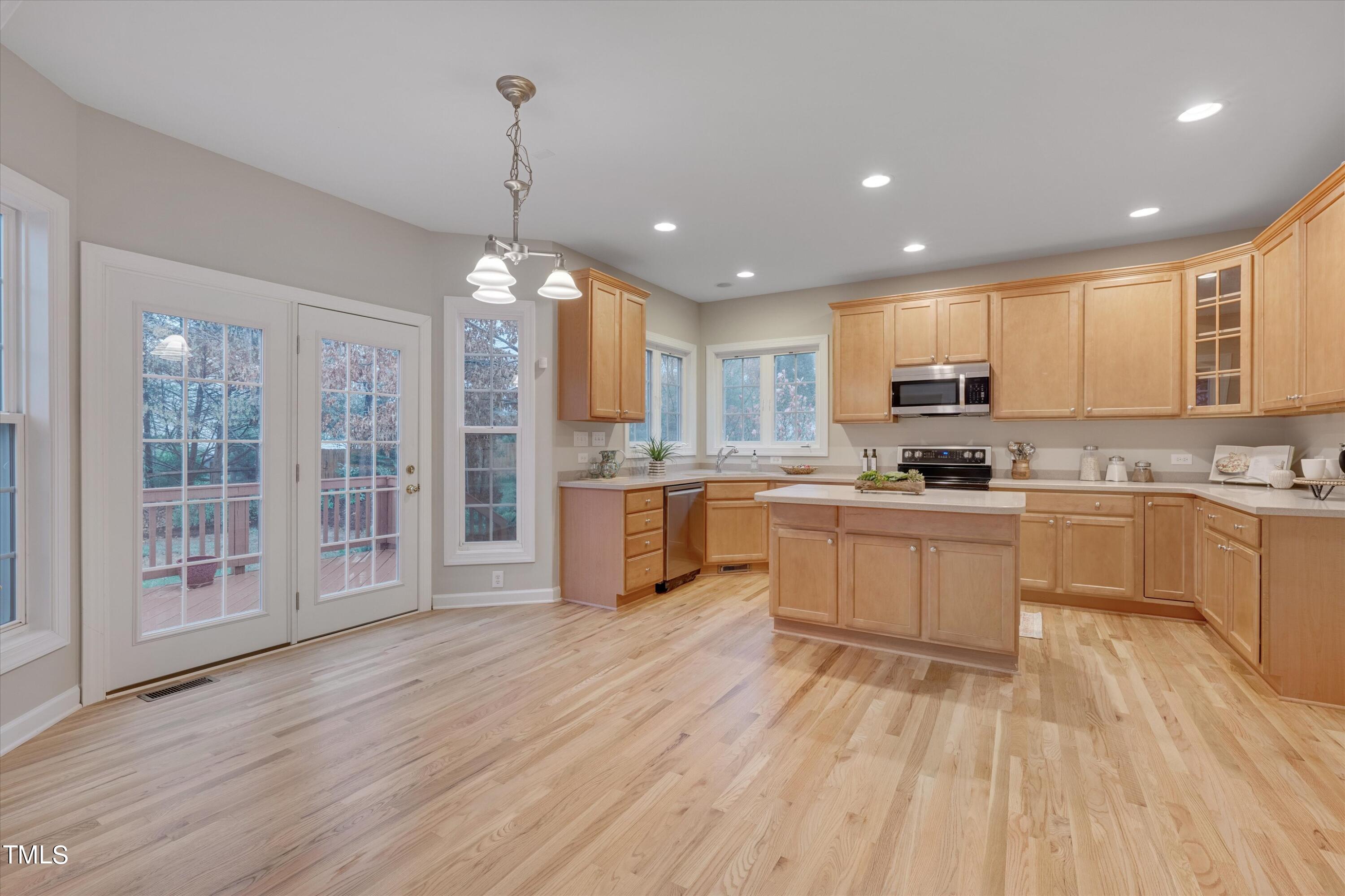 518 Panthers Run Drive Durham, NC 27713 - Photo 12 of 39 a kitchen with stainless steel appliances granite countertop a refrigerator a sink dishwasher a stove and white countertops with wooden floor