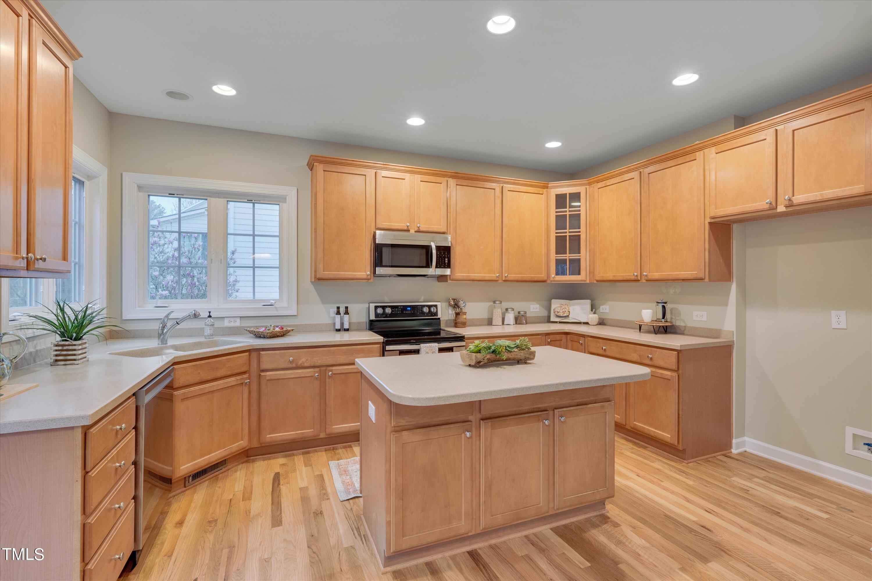 518 Panthers Run Drive Durham, NC 27713 - Photo 14 of 39 a kitchen with a sink window and cabinets