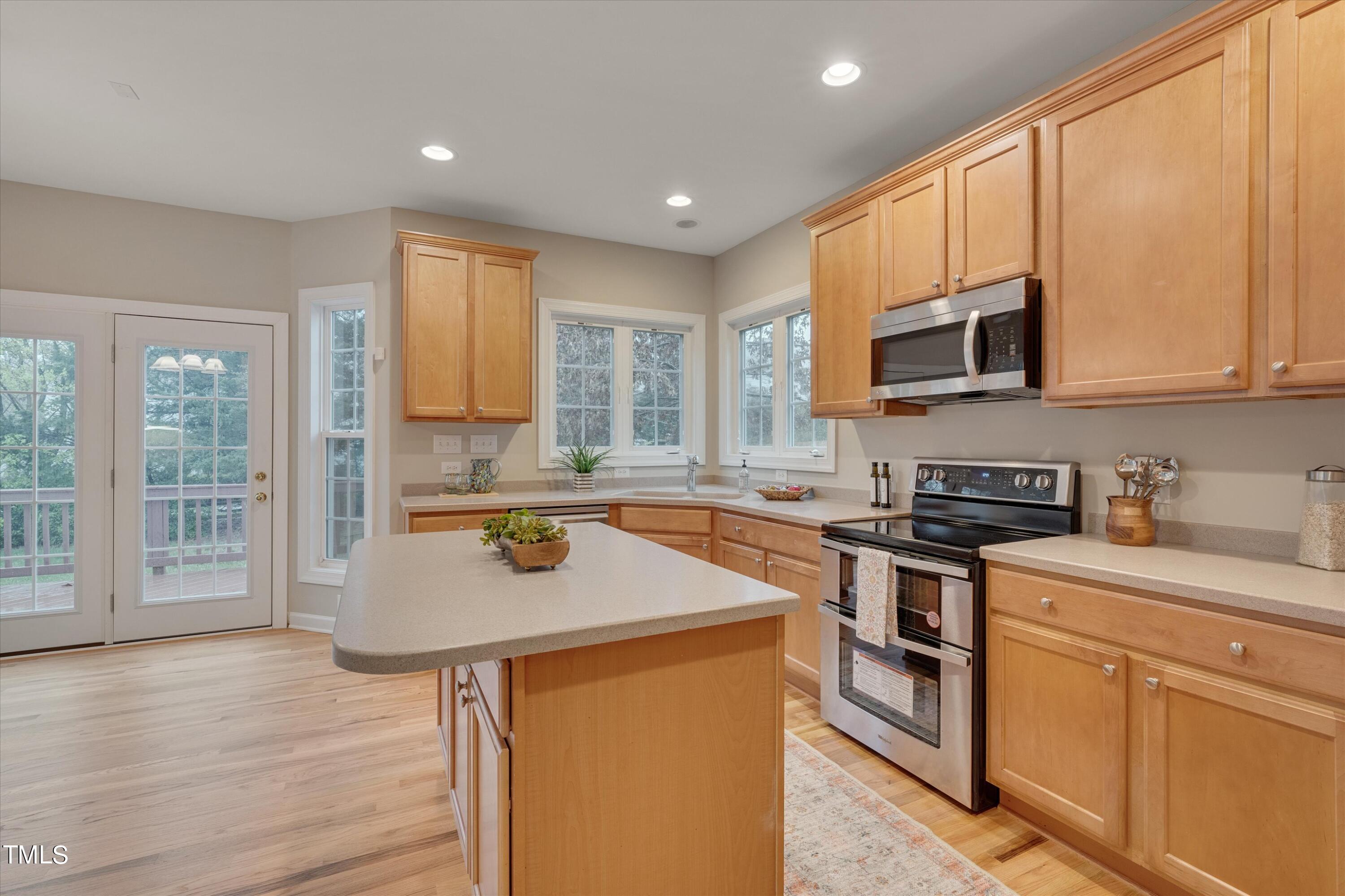 518 Panthers Run Drive Durham, NC 27713 - Photo 15 of 39 a kitchen with stainless steel appliances granite countertop a stove a sink a microwave a refrigerator and cabinets