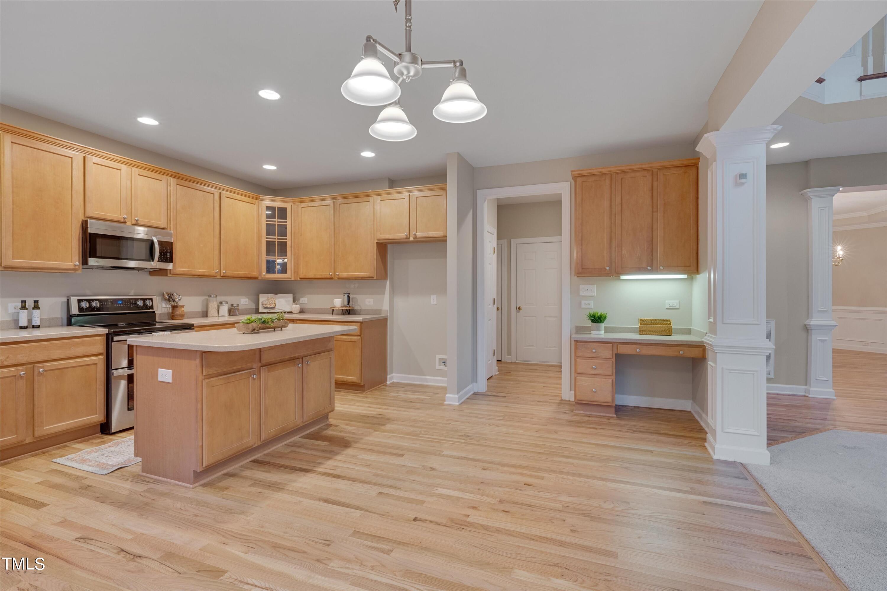 518 Panthers Run Drive Durham, NC 27713 - Photo 17 of 39 a large kitchen with stainless steel appliances granite countertop a stove a sink dishwasher and a refrigerator with wooden floor