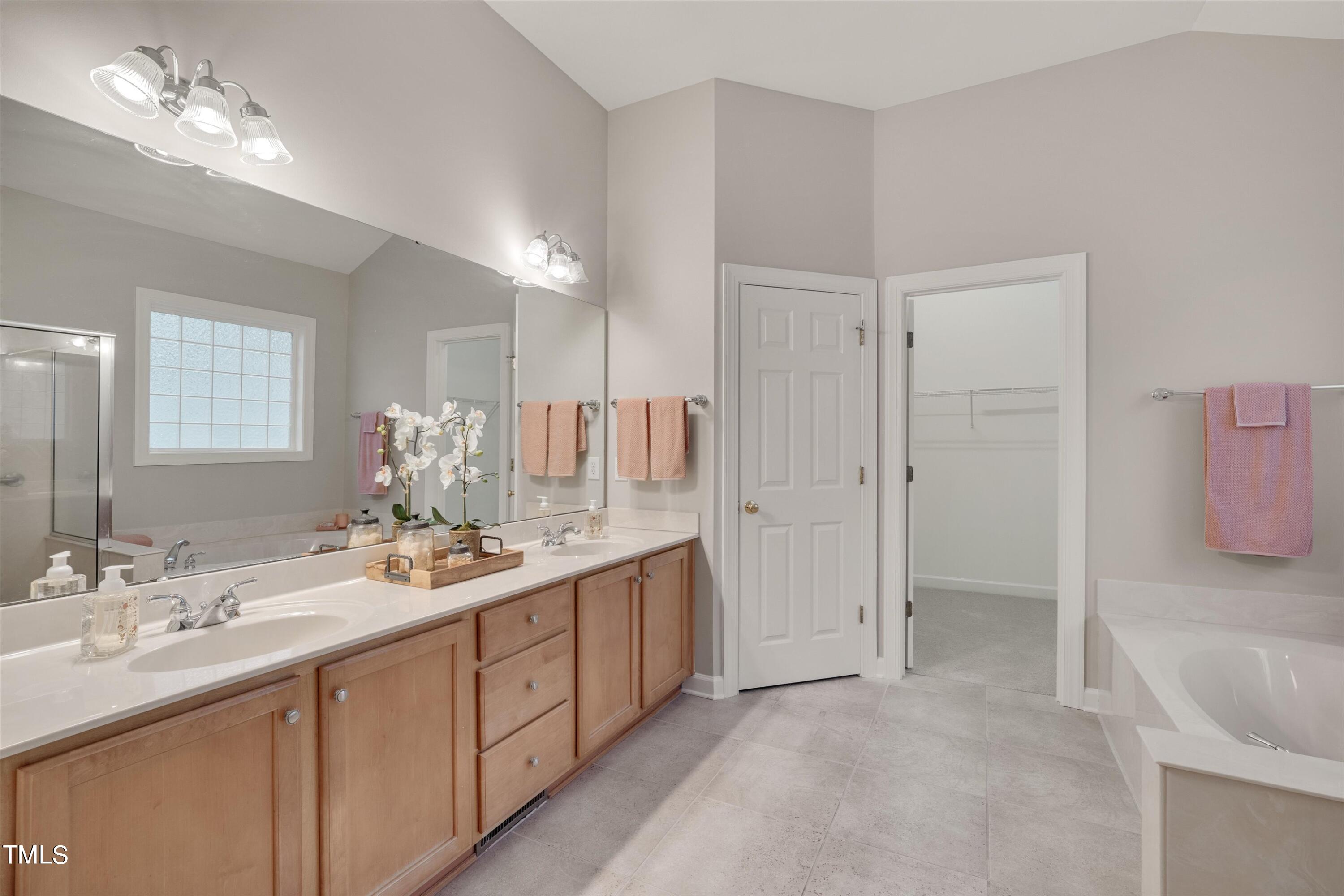 518 Panthers Run Drive Durham, NC 27713 - Photo 22 of 39 a bathroom with a double vanity sink a mirror and a shower