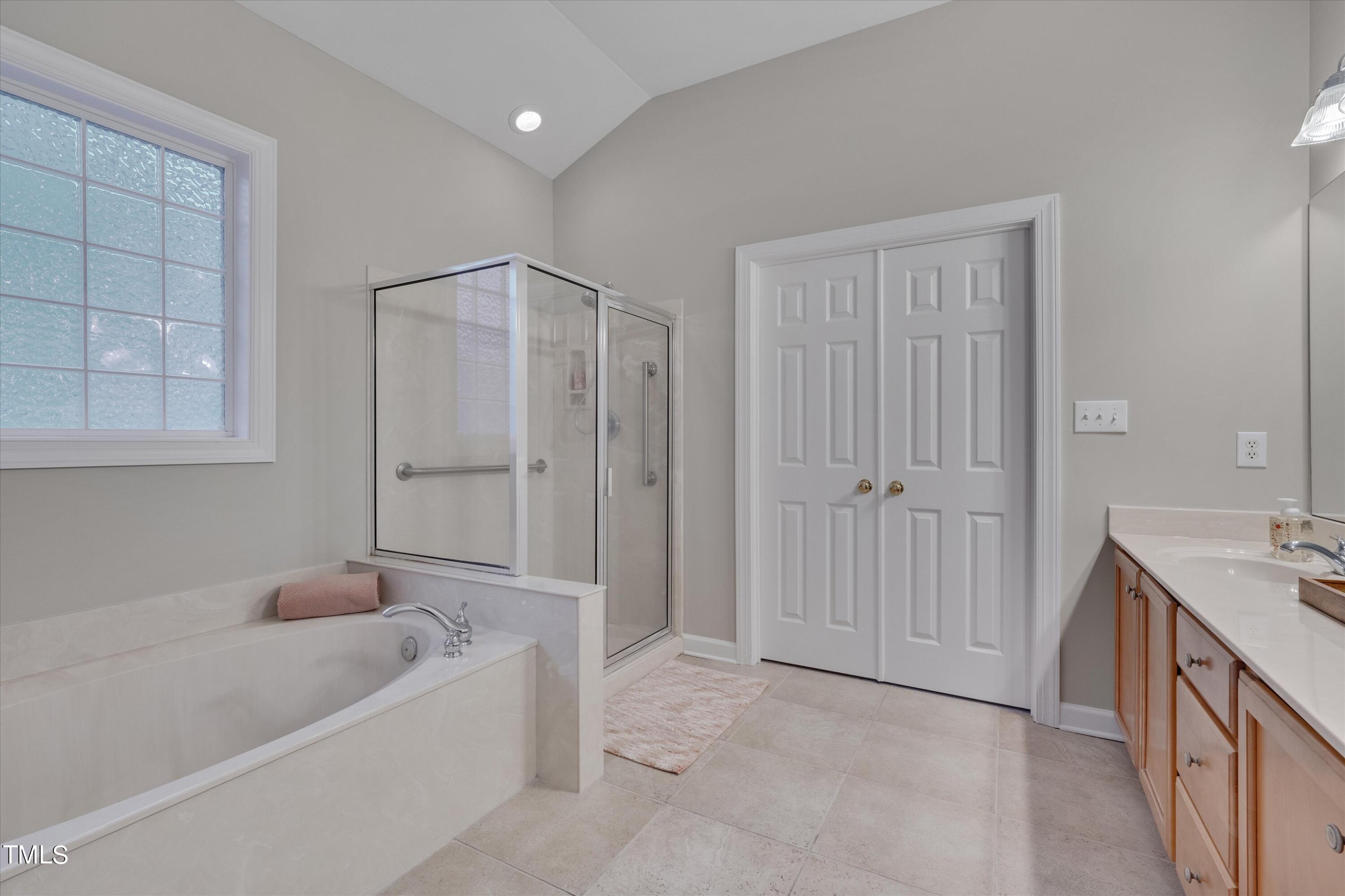 518 Panthers Run Drive Durham, NC 27713 - Photo 23 of 39 a bathroom with a tub a sink and a shower