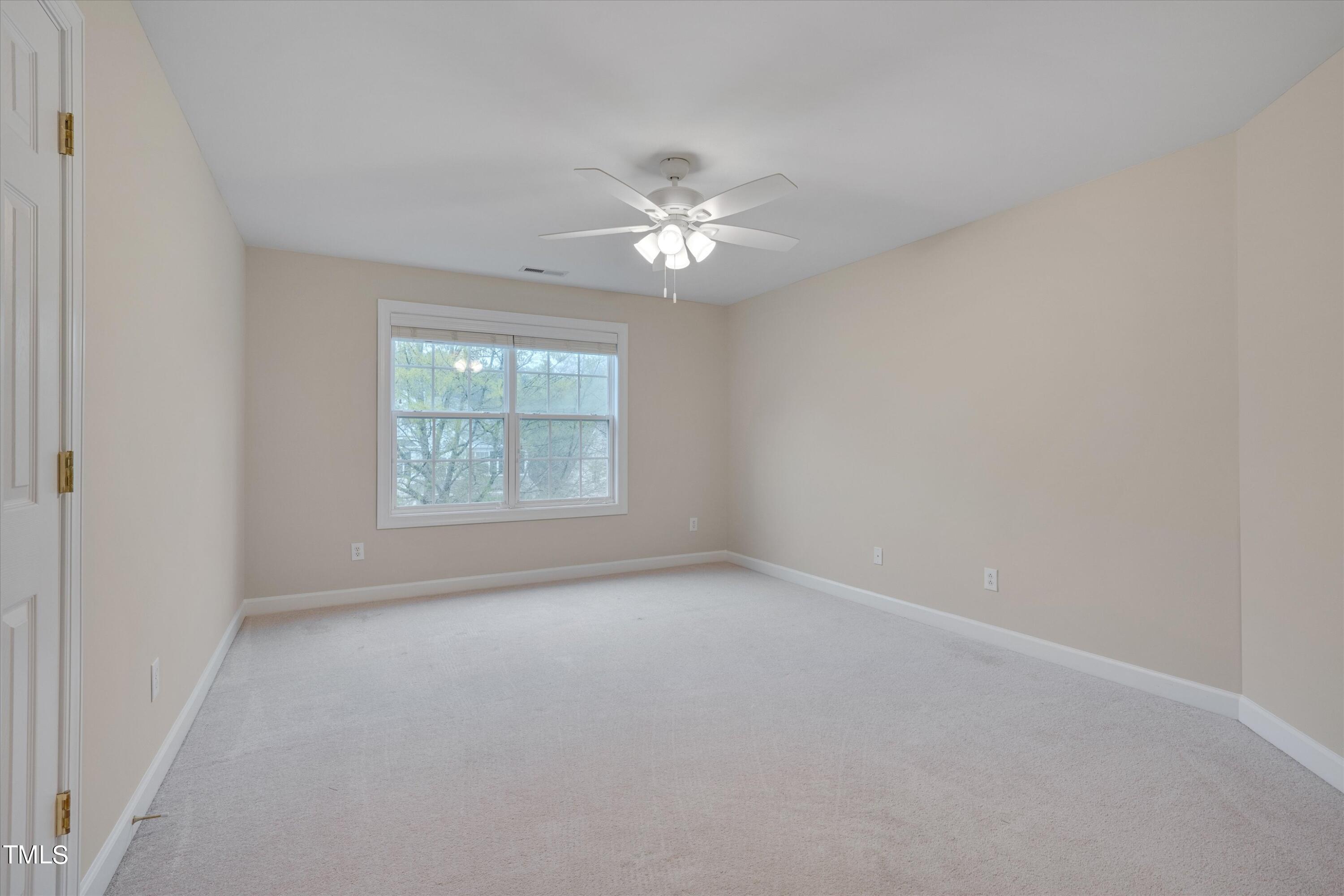 518 Panthers Run Drive Durham, NC 27713 - Photo 26 of 39 an empty room with a window and a fan