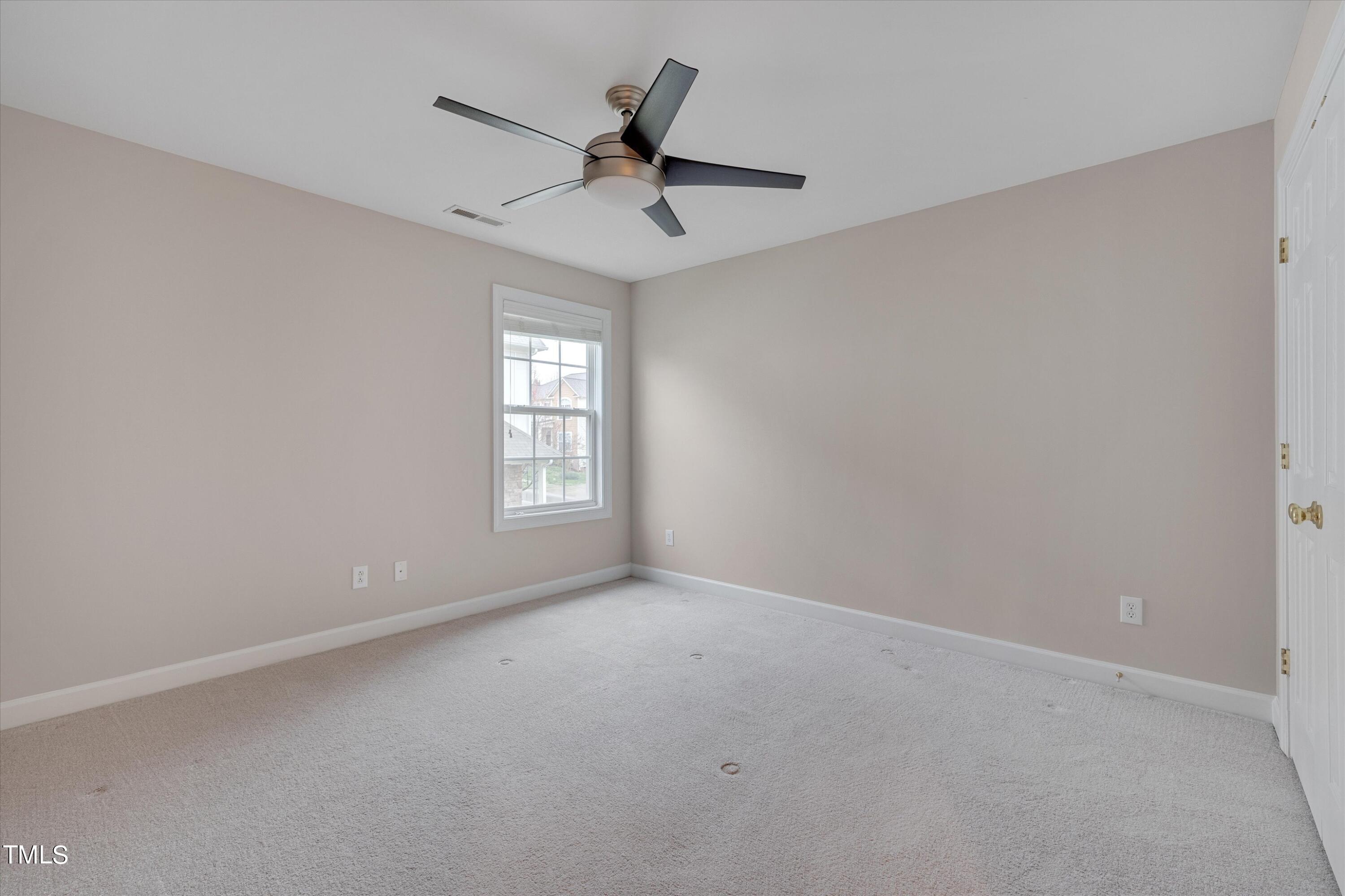 518 Panthers Run Drive Durham, NC 27713 - Photo 29 of 39 an empty room with a ceiling fan and window
