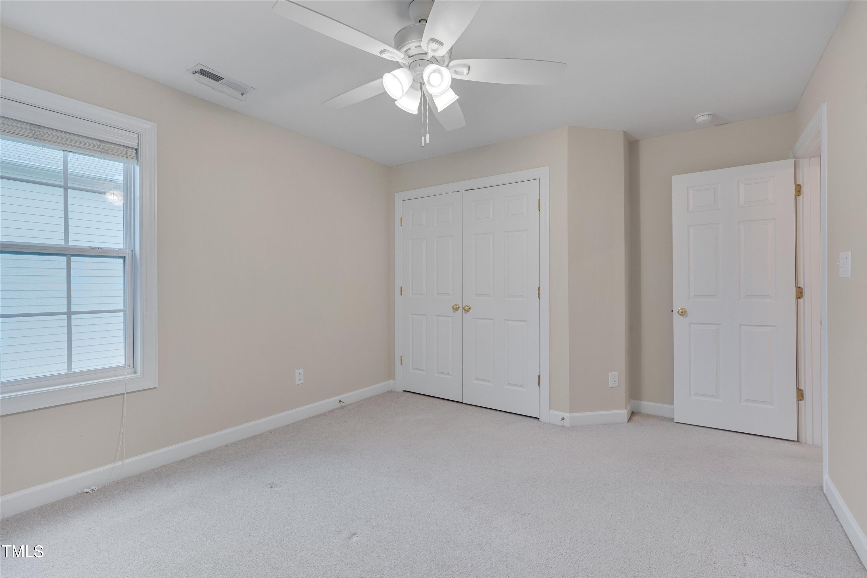 518 Panthers Run Drive Durham, NC 27713 - Photo 31 of 39 an empty room with windows and fan