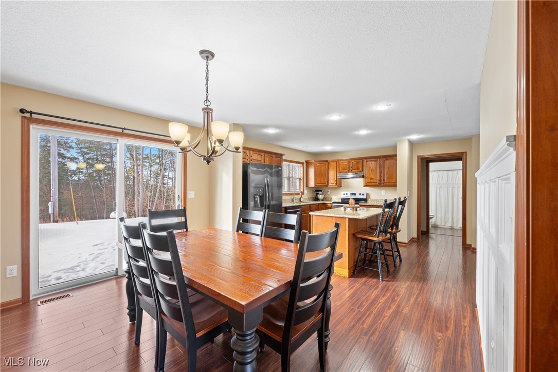 399 Wilder Road Vinton, OH 45686 - Photo 8 of 36 Dining area with a chandelier and dark wood-style flooring