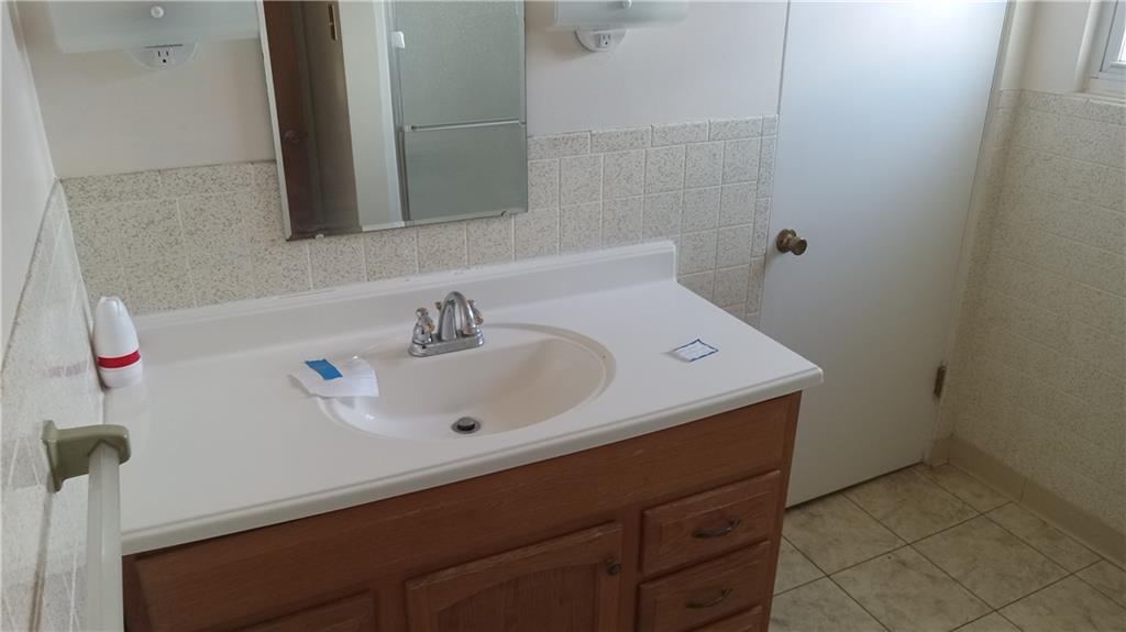 936 Ormond Street Brackenridge, PA 15014 - Photo 23 of 24 a bathroom with a sink and a mirror
