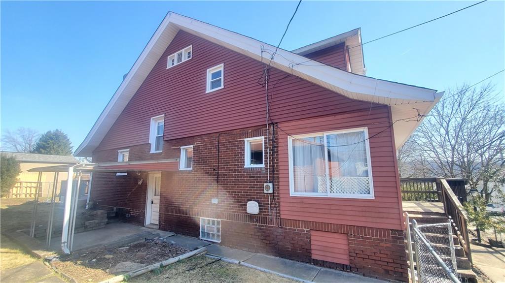 936 Ormond Street Brackenridge, PA 15014 - Photo 5 of 24 a front view of a house with a yard