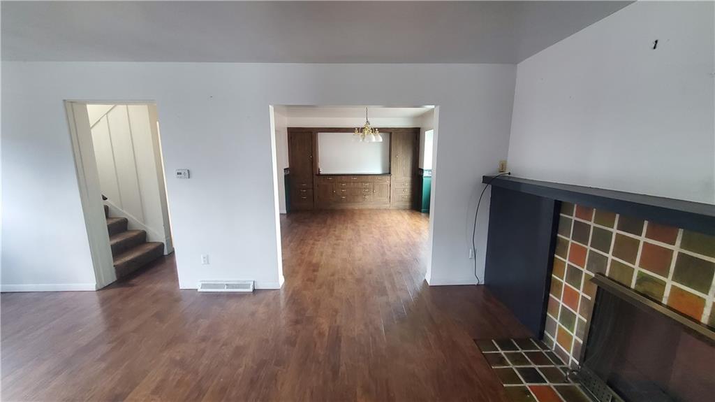 936 Ormond Street Brackenridge, PA 15014 - Photo 10 of 24 wooden floor in an empty room with a fireplace