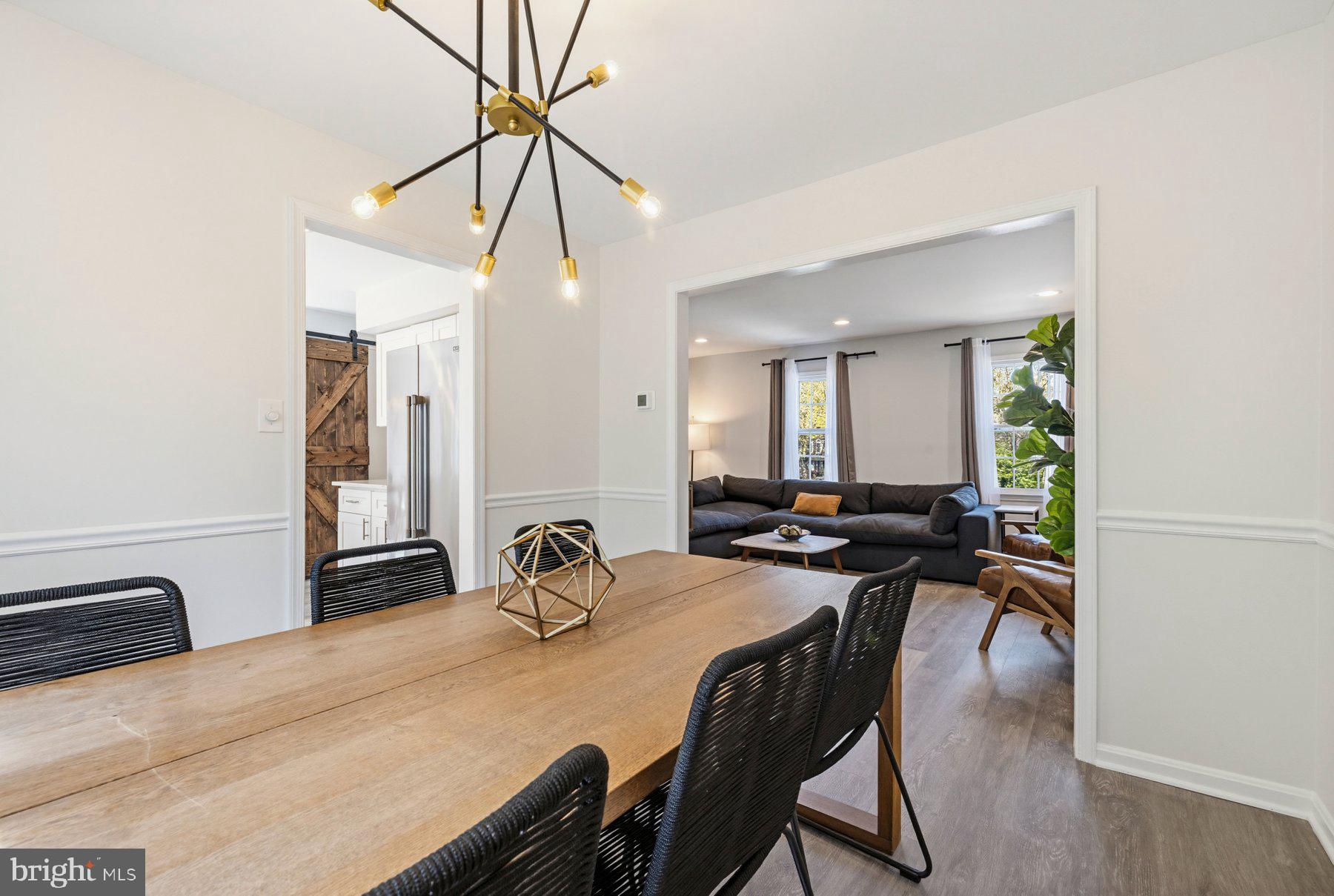 7305 Langsford Court Springfield, VA 22153 - Photo 11 of 46 a dining room with furniture and a chandelier