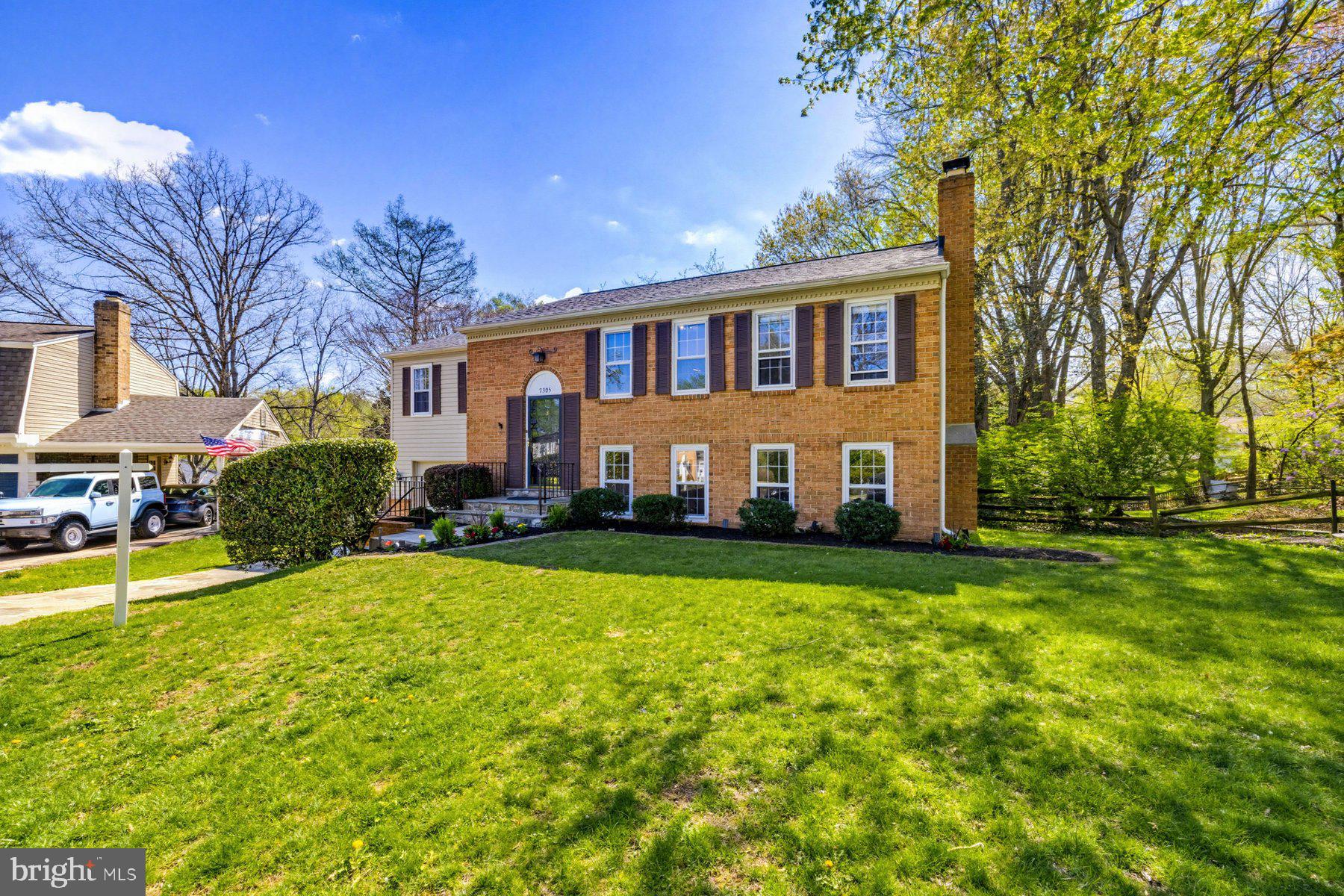 7305 Langsford Court Springfield, VA 22153 - Photo 2 of 46 a front view of a house with a yard