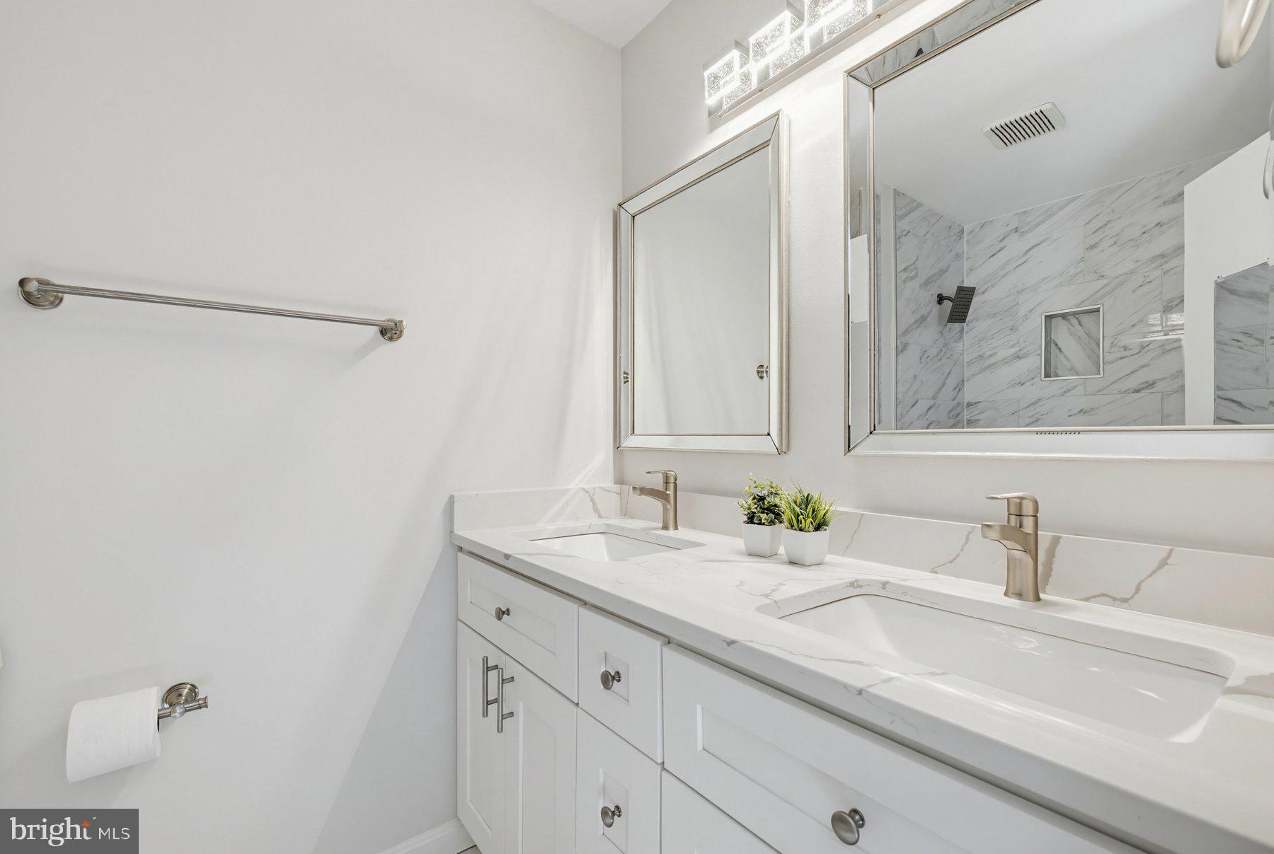 7305 Langsford Court Springfield, VA 22153 - Photo 22 of 46 a bathroom with a sink and a mirror