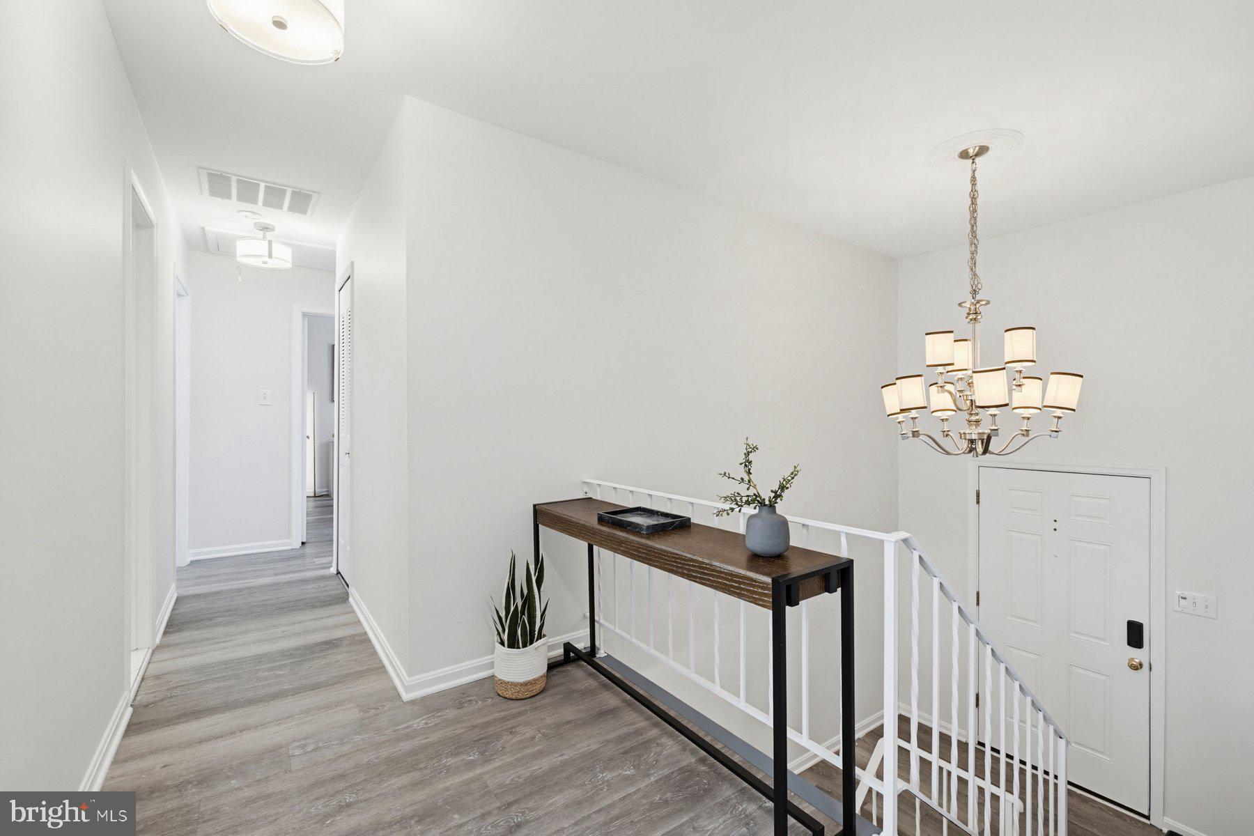7305 Langsford Court Springfield, VA 22153 - Photo 28 of 46 a view of a hallway with chandelier