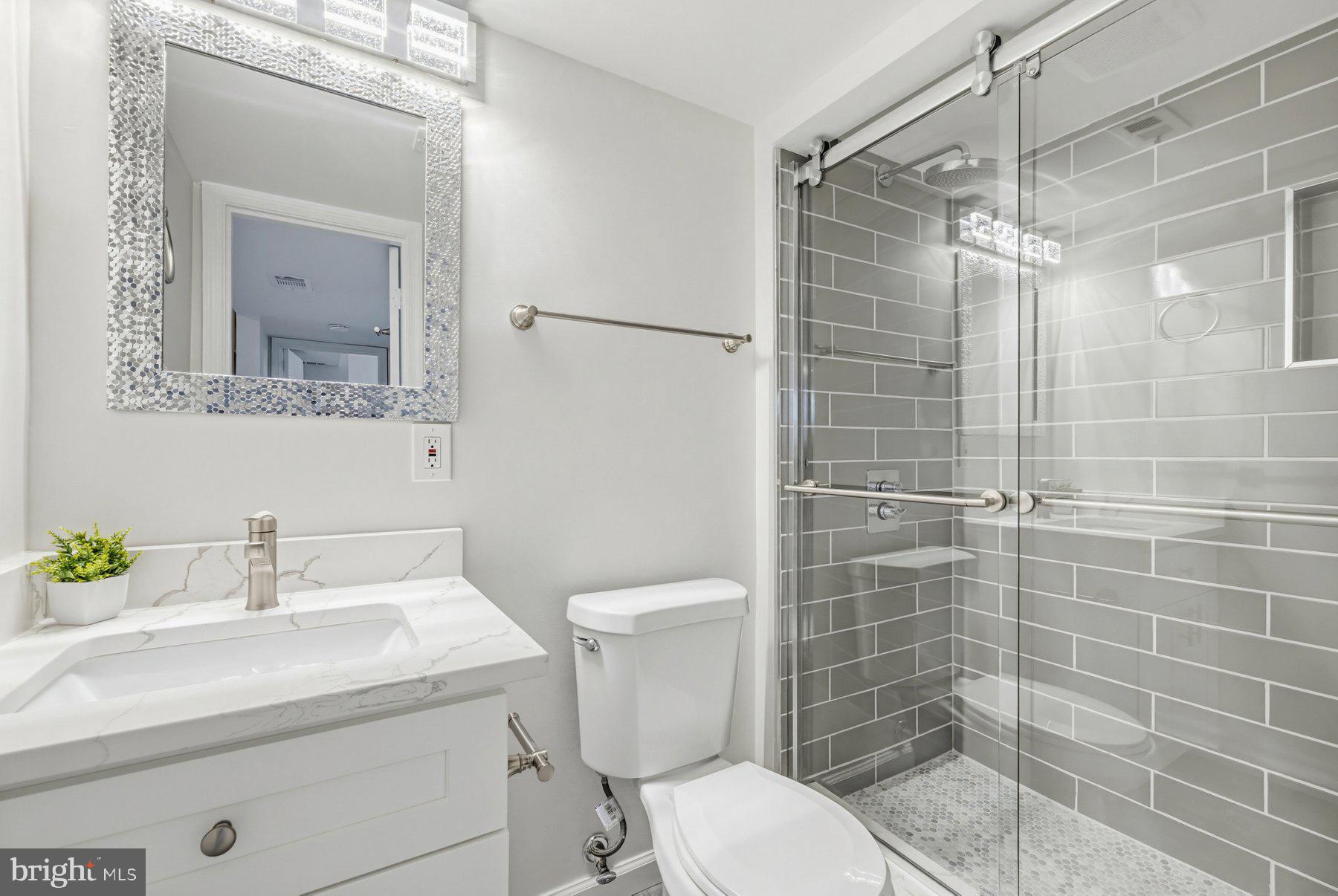 7305 Langsford Court Springfield, VA 22153 - Photo 33 of 46 a bathroom with a sink a toilet and shower
