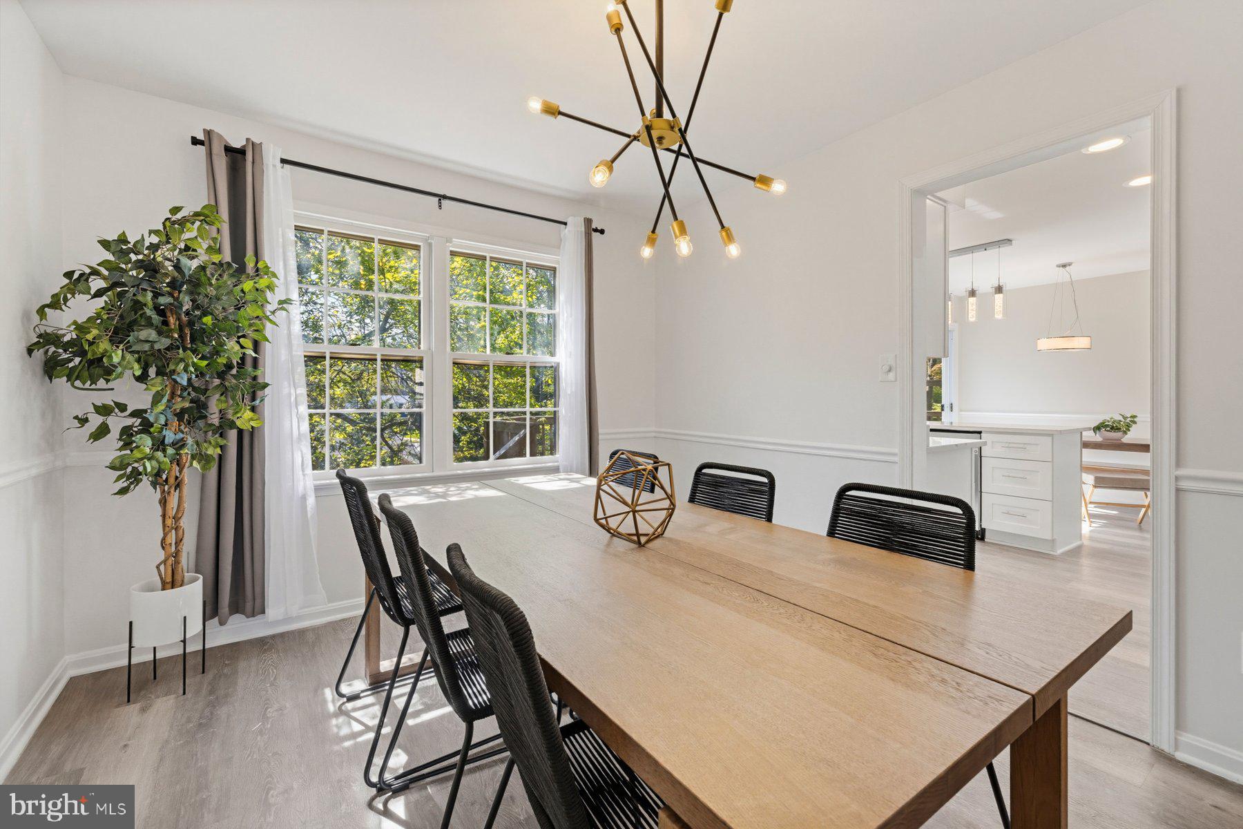 7305 Langsford Court Springfield, VA 22153 - Photo 10 of 46 a view of a dining room with furniture and wooden floor