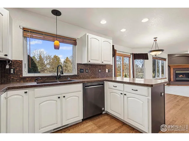 a kitchen with granite countertop a sink stainless steel appliances and cabinets