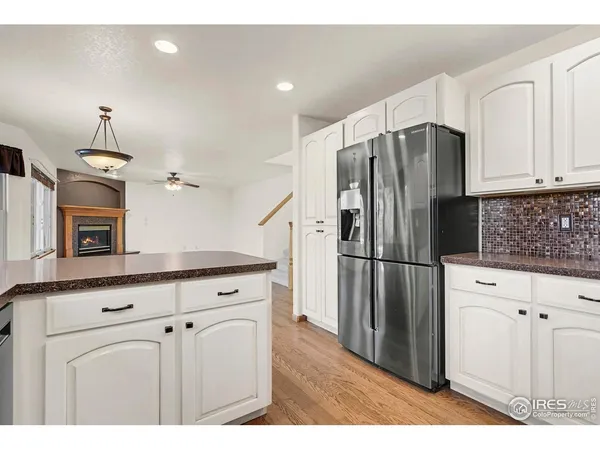 a kitchen with stainless steel appliances a refrigerator sink and cabinets