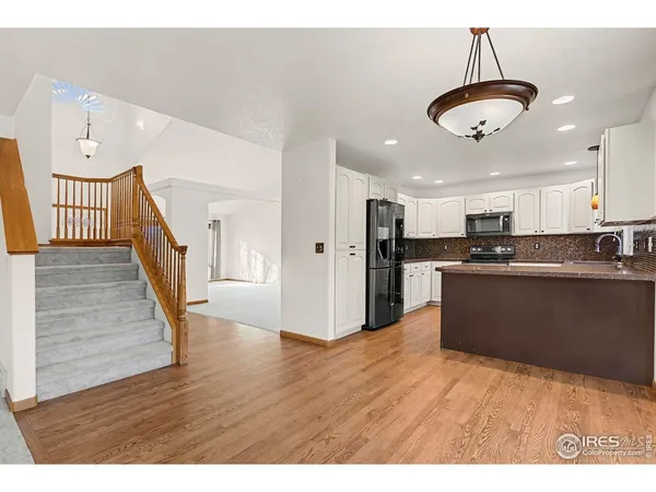 a kitchen with stainless steel appliances a refrigerator sink and cabinets