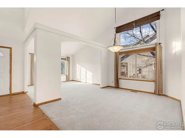 a living room with furniture fireplace and a large window