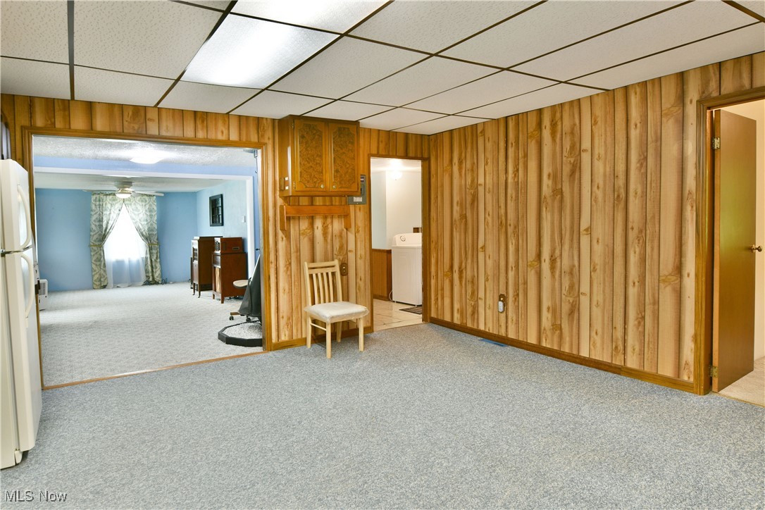 5578 Shaffer Road Northwest Warren, OH 44481 - Photo 24 of 48 Empty room featuring carpet flooring, wooden walls, and washer / clothes dryer