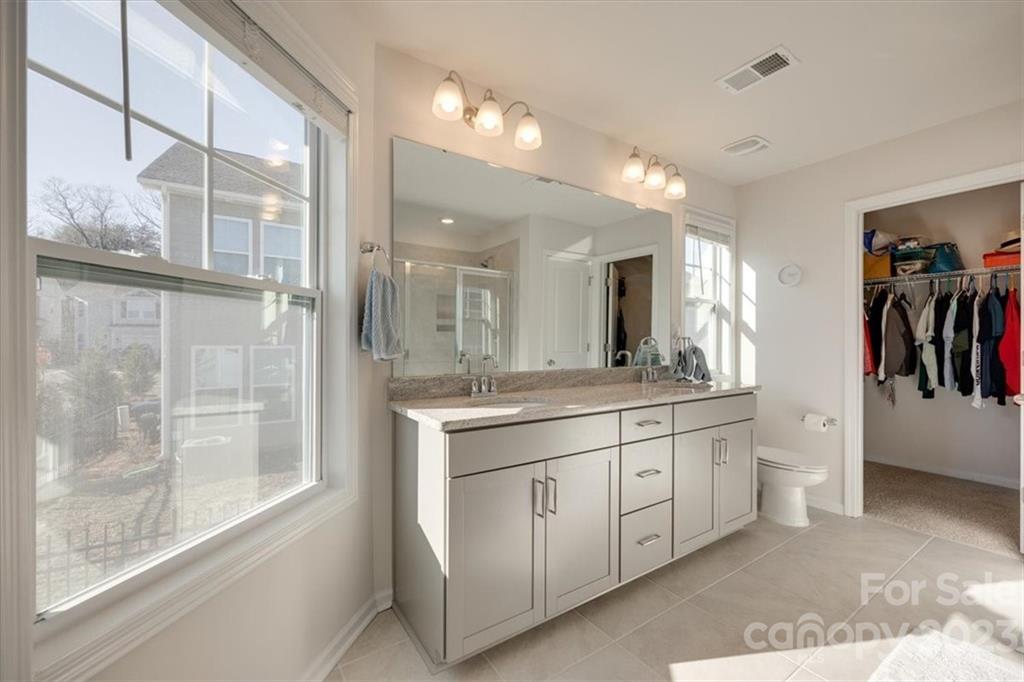 311 Bulrush Rd Lake Lake Wylie, SC 29710 - Photo 20 of 35 a bathroom with a double vanity sink and a mirror