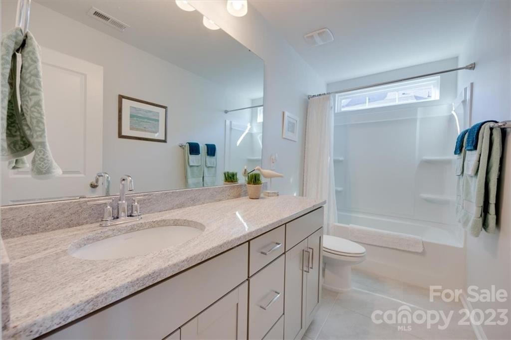 311 Bulrush Rd Lake Lake Wylie, SC 29710 - Photo 25 of 35 a bathroom with a granite countertop sink a toilet and shower