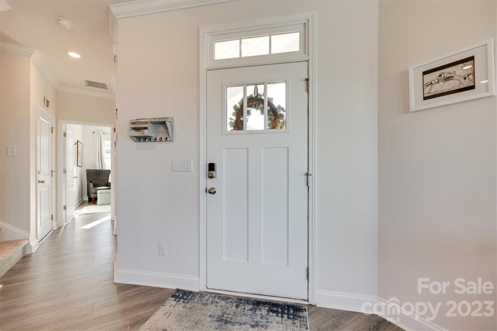 311 Bulrush Rd Lake Lake Wylie, SC 29710 - Photo 4 of 35 a view of a hallway with wooden floor and a window