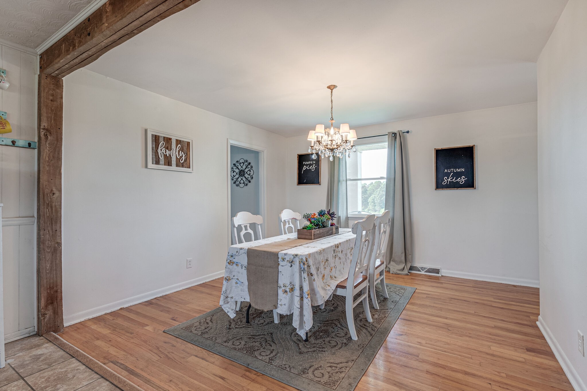 540 Cook Road Portland, TN 37148 - Photo 16 of 32 a view of a dining room with furniture a chandelier and wooden floor
