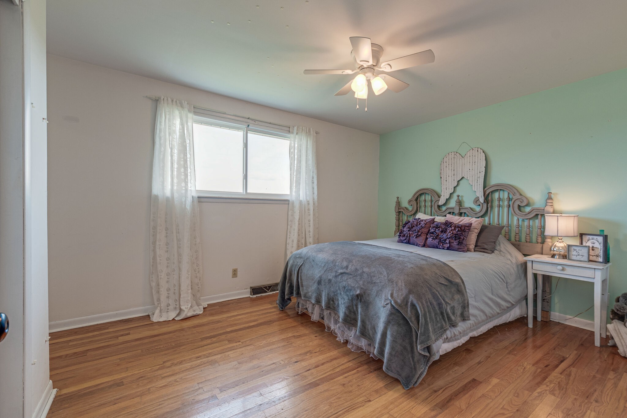 540 Cook Road Portland, TN 37148 - Photo 22 of 32 a bedroom with a large bed and a chandelier