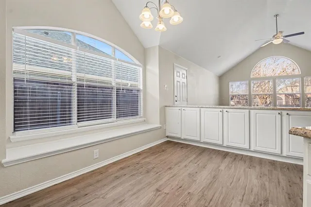 a view of a livingroom with a window and wooden floor