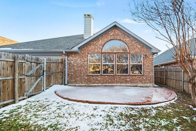 a view of a house with a wooden fence