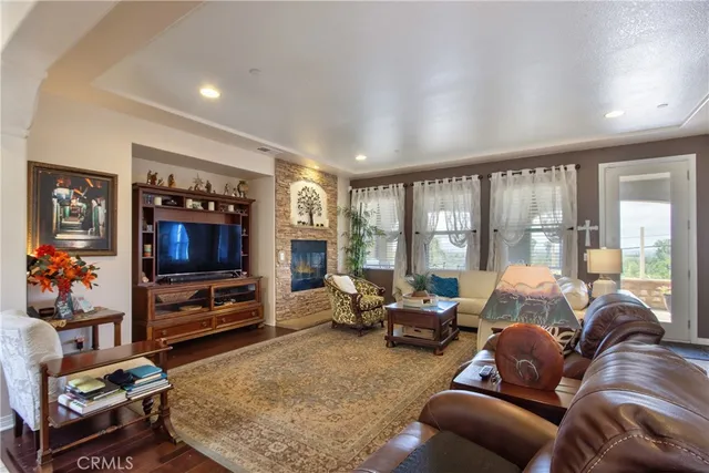 a dining room filled chandelier and kitchen view