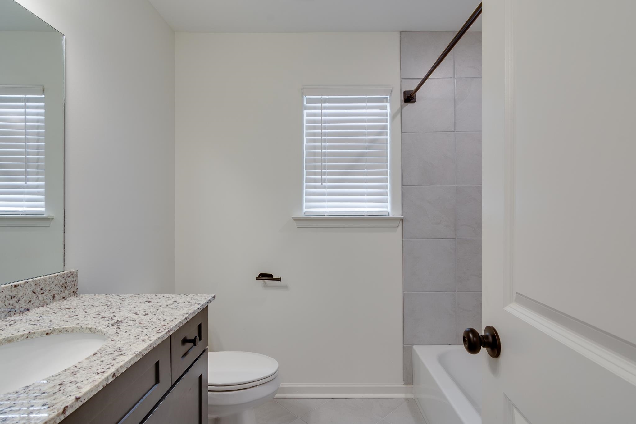 155 Misty Ridge Loop Oakland, TN 38060 - Photo 19 of 26 a bathroom with a granite countertop sink toilet and shower