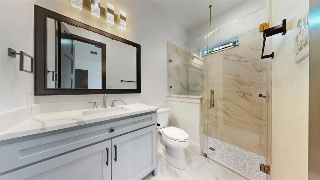 1860 Old Telico Road Ennis, TX 75119 - Photo 19 of 40 a bathroom with a toilet sink and mirror