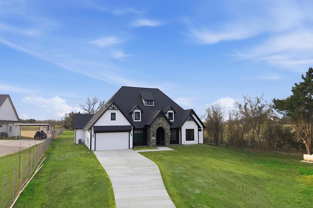 1860 Old Telico Road Ennis, TX 75119 - Photo 2 of 40 a front view of a house with a yard