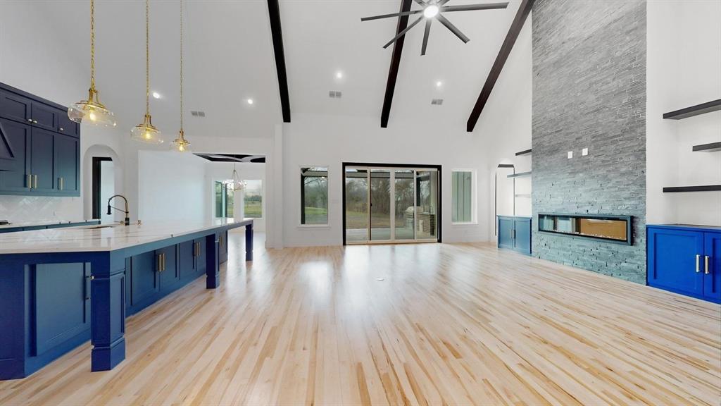 1860 Old Telico Road Ennis, TX 75119 - Photo 5 of 40 a open kitchen with stainless steel appliances granite countertop a lot of counter space and wooden floors