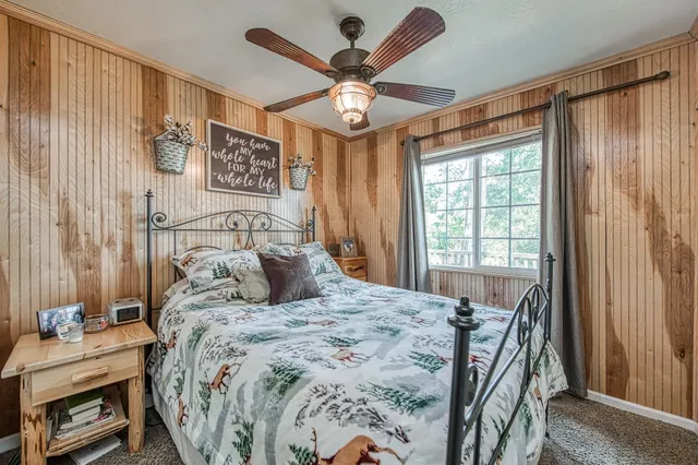 a bedroom with a bed and a chandelier