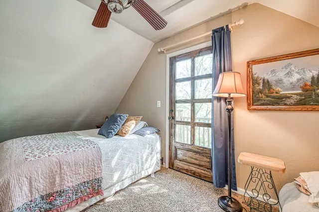 a bedroom with a bed and a mirror