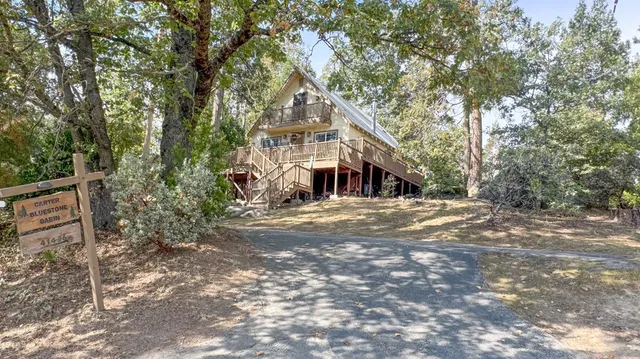 a backyard of a house with barbeque oven table and chairs