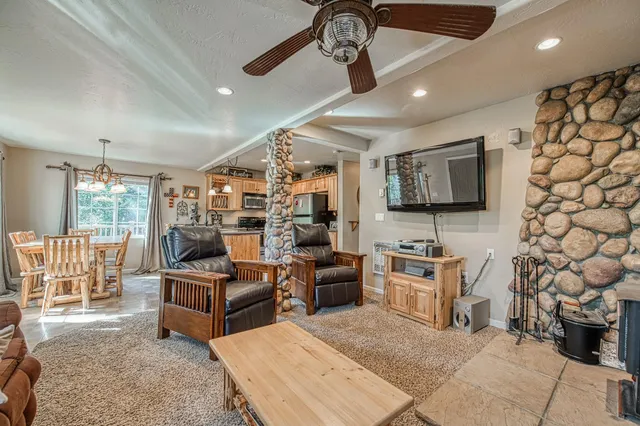 a living room with fireplace furniture and a flat screen tv