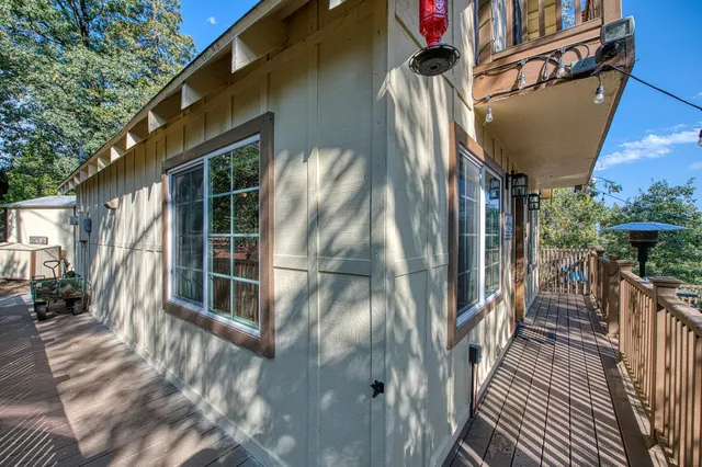 a view of balcony with wooden floor and fence