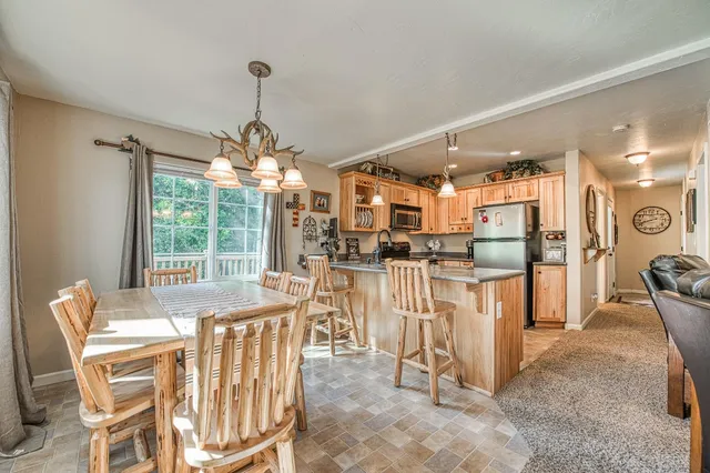 a dining room filled with furniture and a chandelier