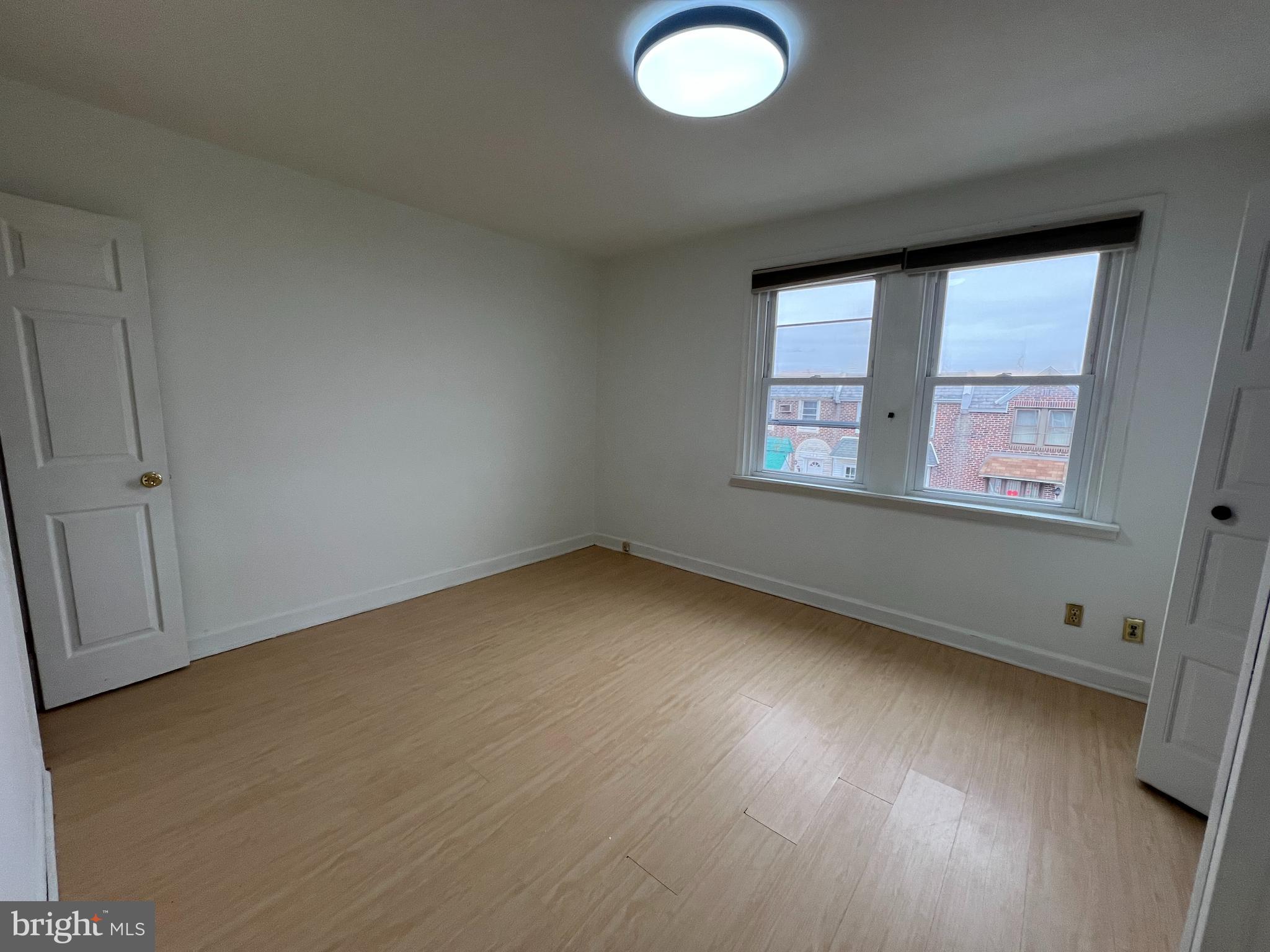4312 Loring Street Philadelphia, PA 19136 - Photo 11 of 14 an empty room with wooden floor and windows