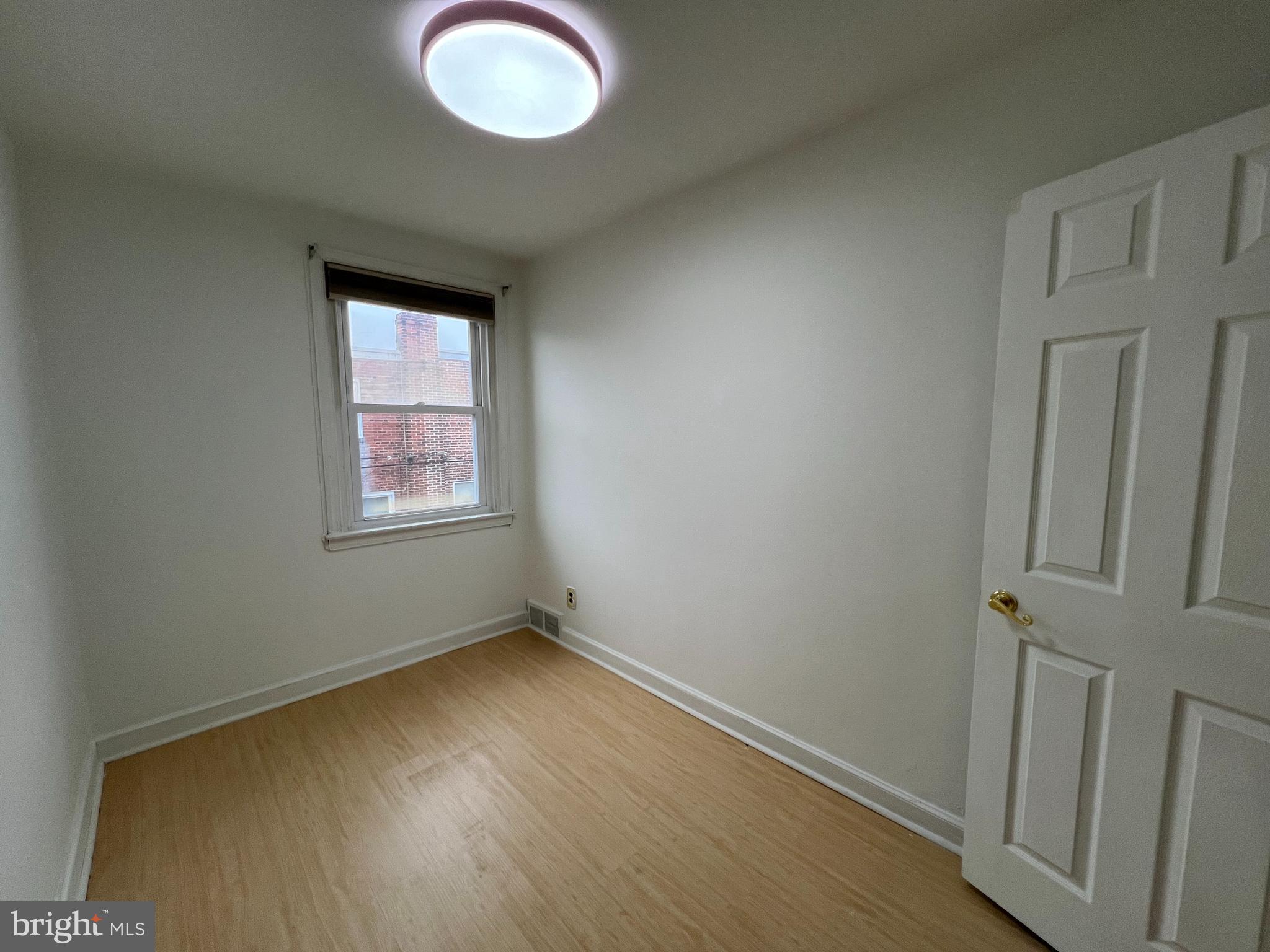 4312 Loring Street Philadelphia, PA 19136 - Photo 14 of 14 an empty room with wooden floor and windows